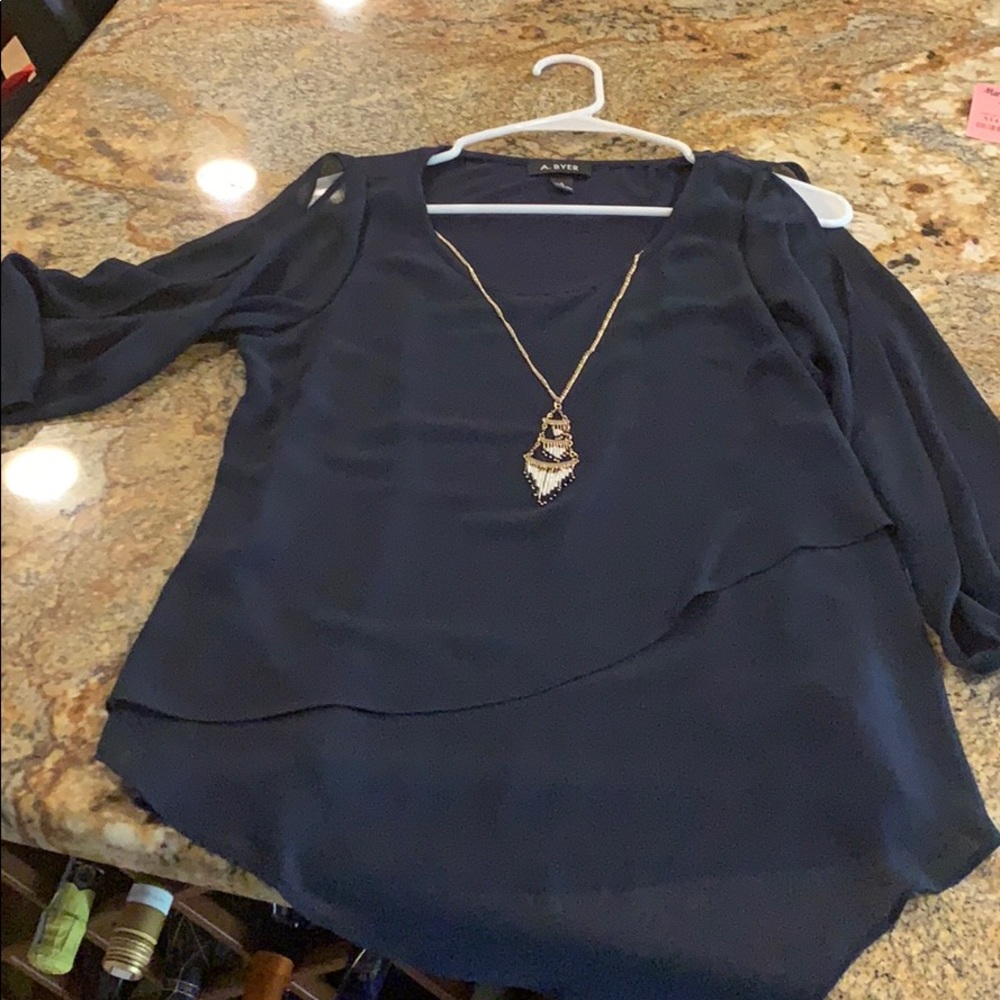 Fun and flowy he navy blue top with necklace.